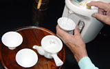 Warm up tea bowls and measure the amount of hot water.